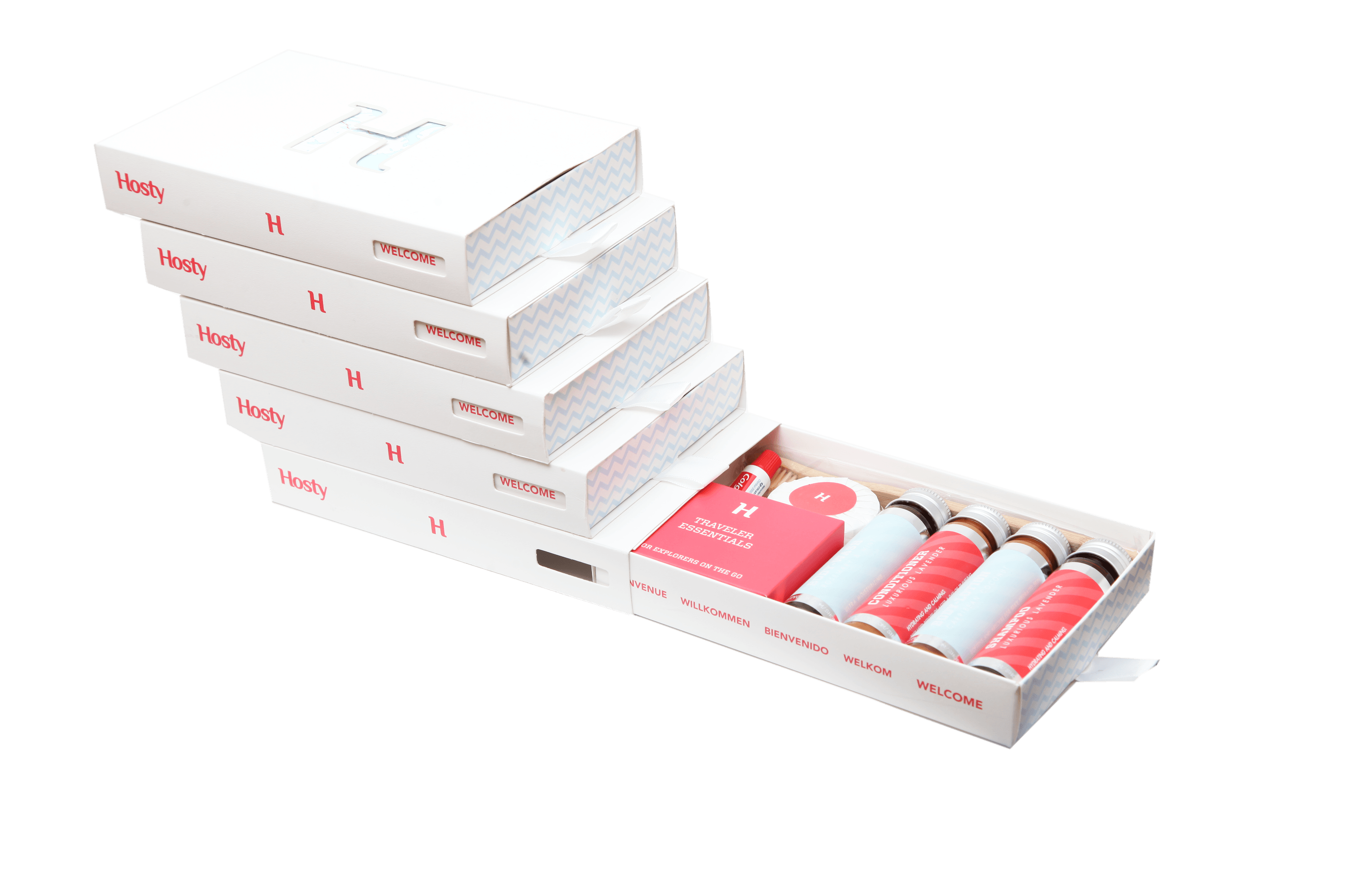 A stack of final white Hosty drawer boxes with one drawer open to reveal the complete guest amenity set